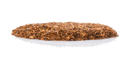 Dried rooibos herbal tea leaves over white background