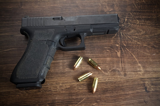 Pistol gun on wooden background
