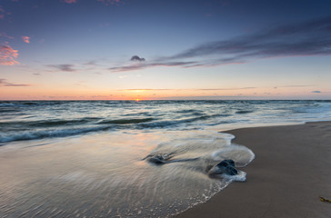 Baltic sea coast at picturesque sunset in Rowy, near Ustka, Poland