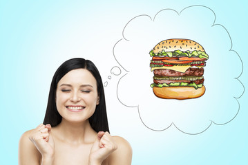 A brunette woman is thinking about burger. A fast food concept. Blue background.