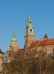 Fototapeta premium Sigismund, Clock and Silver Bells towers of the St Stanislaw and St Vaclav cathedral on the Wawel Hill with the fortifications of the Wawel castle
