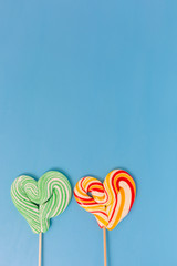 Heart shaped lollipop for Valentine's Day with turquoise backgro