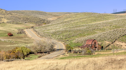 Country road and red barn and farm