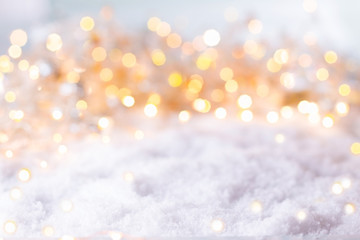 Abstract winter background with snow and golden lights