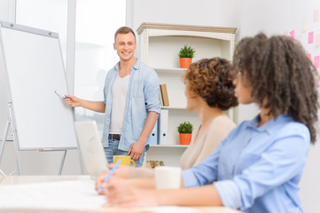 Fototapeta premium Three colleagues in the middle of informal deliberation.