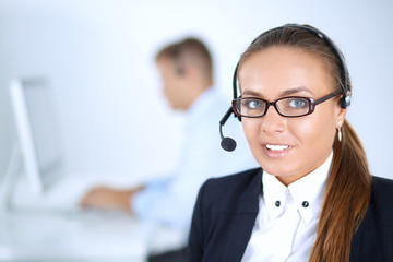 Happy female wearing headset and sitting on the desk
