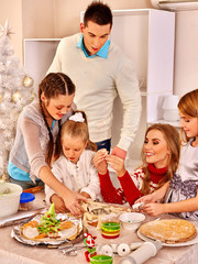 Obraz na płótnie Canvas Family with children rolling dough in Xmas kitchen.