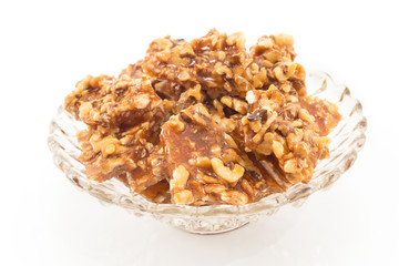 Homemade candies with walnuts in a glass bowl