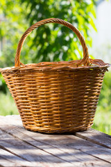 Fototapeta na wymiar basket on old wooden table in garden