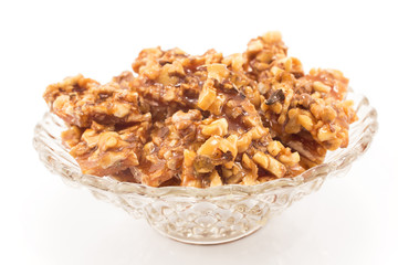 Homemade candies with walnuts in a glass bowl