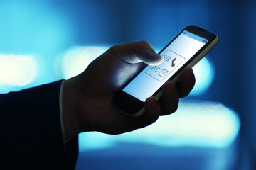 Male hand touching screen phone close-up