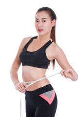 Fitness young woman holding a bottle of water and an apple over white background
