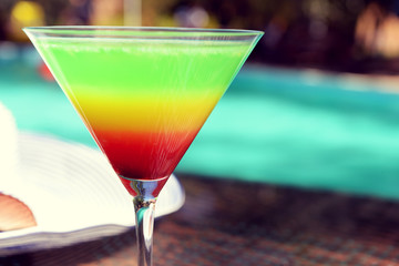 Cocktail on swimming pool background