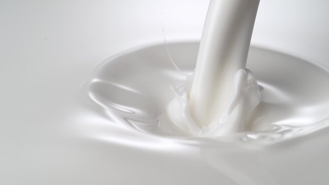 Close-up milky liquid being poured. Shot with high speed camera, phantom flex 4K.  Slow Motion. 