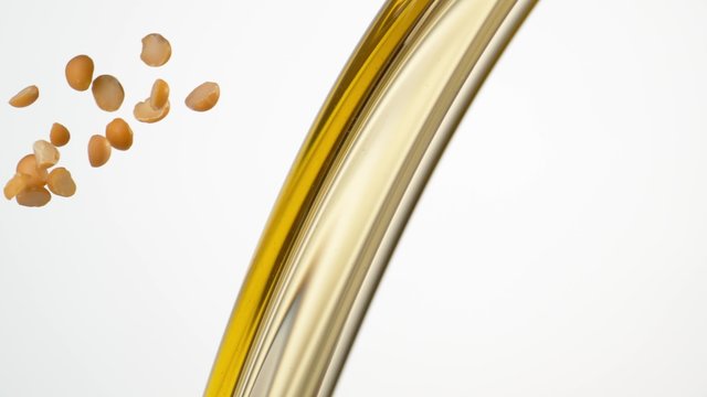 Pouring oil and soy beans. Shot with high speed camera, phantom flex 4K.  Slow Motion. 