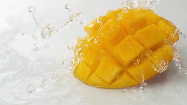 Water splash and mango. Shot with high speed camera, phantom flex 4K. Slow Motion. 
