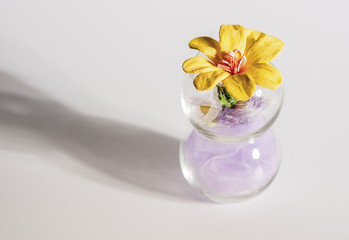 Obraz na płótnie Canvas Bunch of Artificial Decorative Flowers on Transparent Vase