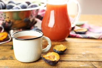 Plum Juice in jar and mug with fresh fruits