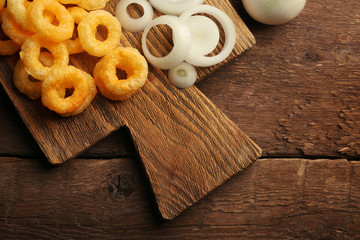 Chips rings with sauce and onion on cutting board