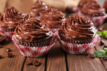 Chocolate cupcakes on wooden background closeup