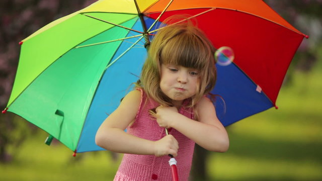 Child with umbrella playing the ape
