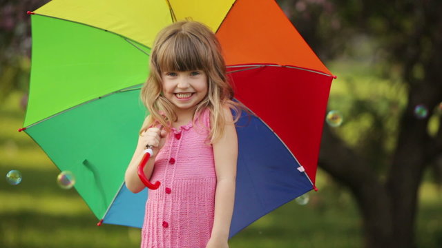 Little kid with umbrella laughing