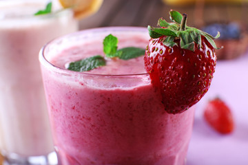 Glasses of fresh cold smoothie with fruit and berries, on the table, close-up