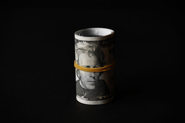 Dollars roll on black background