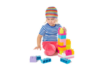  Little girl in a colorful shirt playing with construction toy b - 96412544