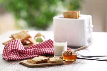 Served table for breakfast with toast, milk and jam, close-up