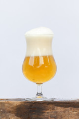 Pouring beer into glass on white background.
