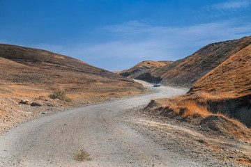 Iraqi countryside in autumn season, with cultivated unpaved road near Kirkuk city