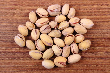 Pistachio nuts on wooden table, healthy eating