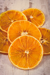 Vintage photo, Slices of dried orange on old wooden background