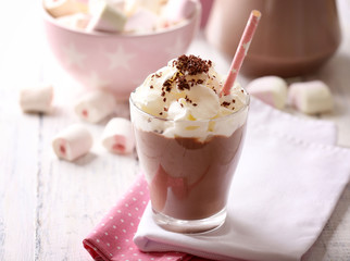 Glass of chocolate milk on table close-up
