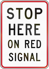 New Zealand road sign RG-30.1 - Stop here on red signal