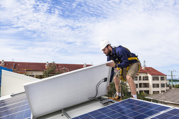 Solar panel technician installing solar panels