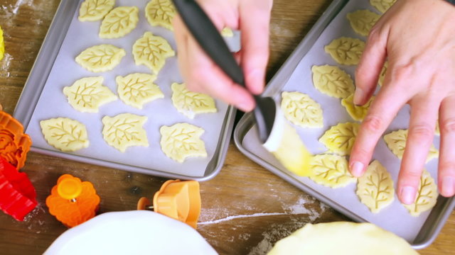 Cutting out Autumn leafs with cookie stamper to decorate pumpkin pie