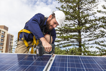 Solar panel technician with drill