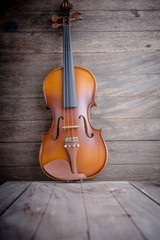 Vintage violin on wooden background