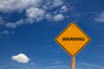 warning yellow traffic sign with blue sky