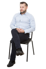 man sitting on chair. Isolated white background, arms crossed, mistrust