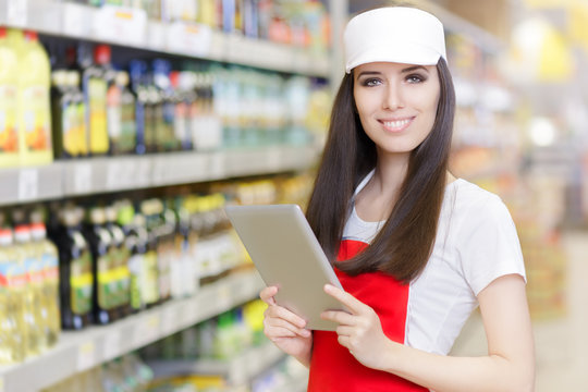 Smiling Supermarket Employee Holding A Pc Tablet