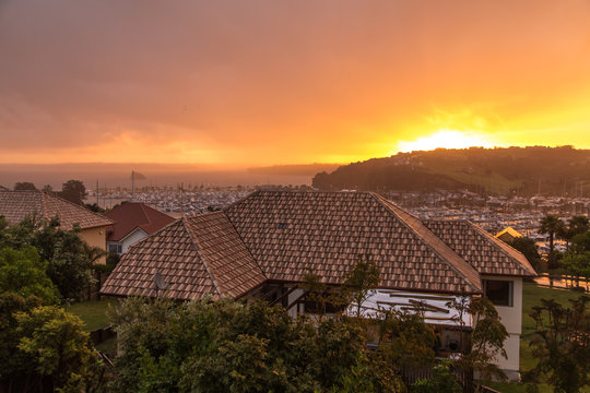 Houses and yahts during rainy sunset 