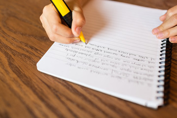 Girl writing by hand on notepad