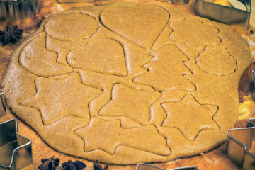 Christmas glazed biscuit shapes imprinted dough Kitchen table wi