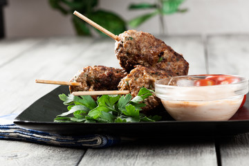 Barbecued kofta with vegetables on a plate