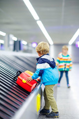 little tired kid boy at the airport, traveling