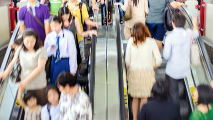 People on escalators in motion