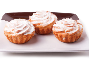 Three fresh muffins on plate isolated